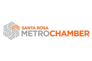 Logo of Santa Rosa Metro Chamber with a geometric design and the text in gray and orange.