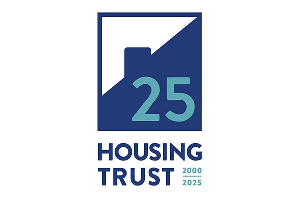 A blue and white logo with a stylized building, number 25, and the text "Housing Trust 2000 2025" beneath it.